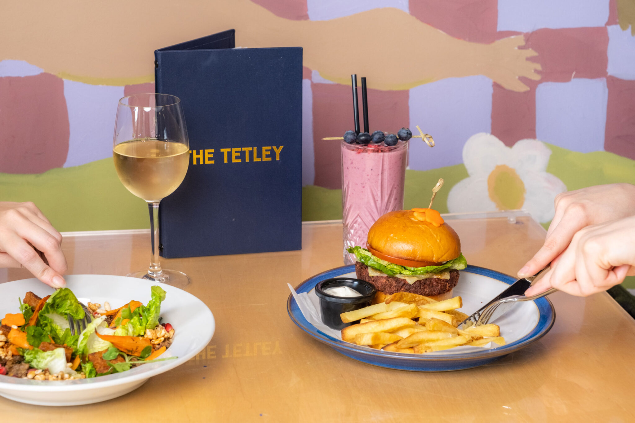 Zero beef burger, salad, wine and milkshake